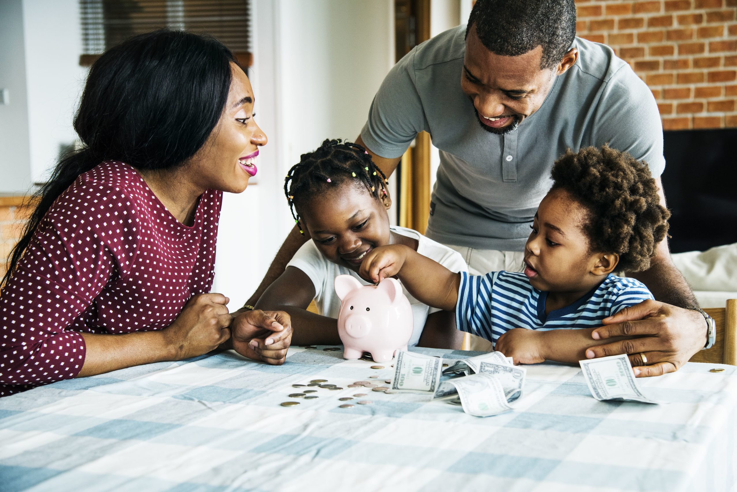 African American Family Saving Money in Piggy Bank